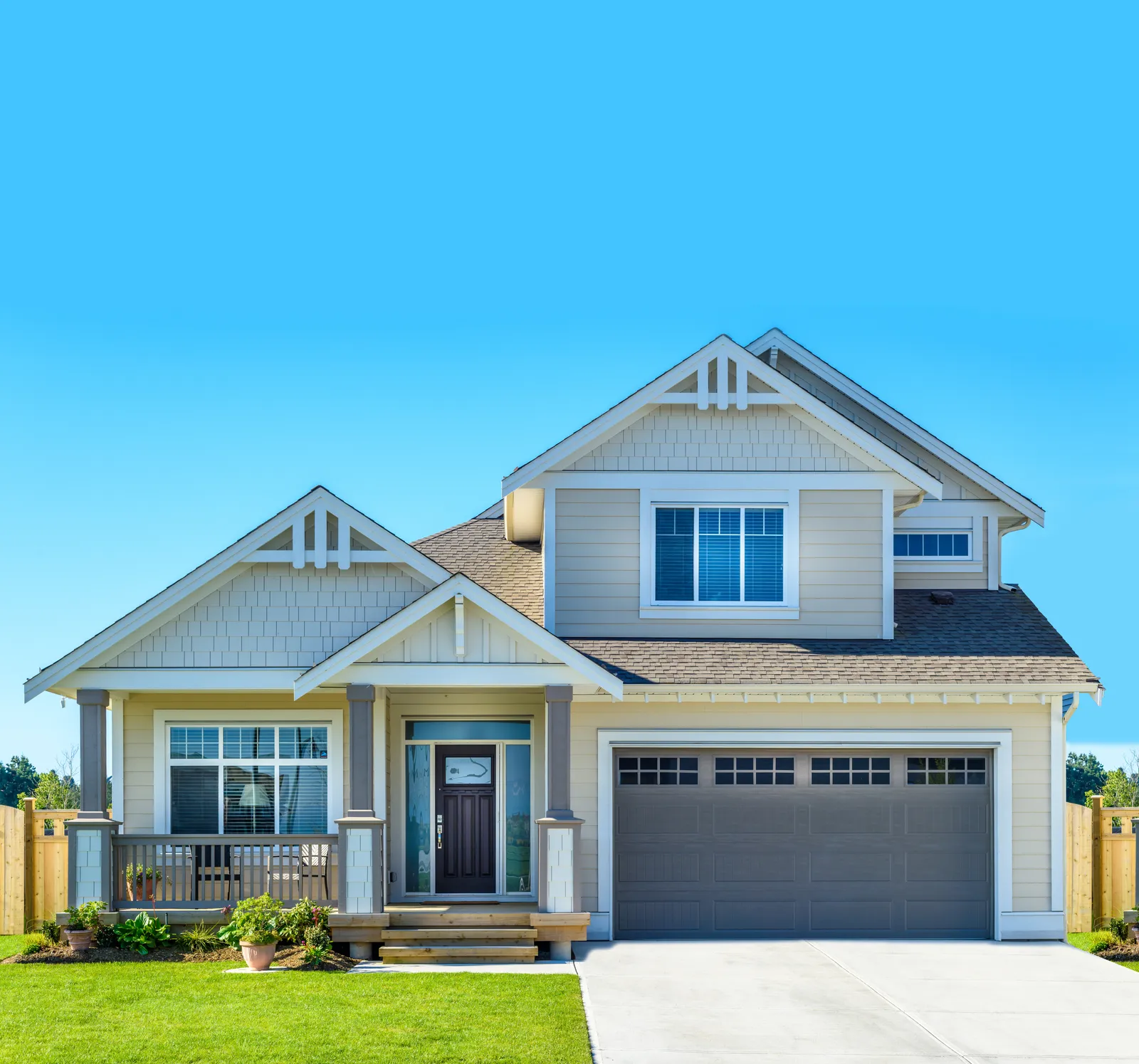 Double garage on a craftsman style home under a gray shingle roof